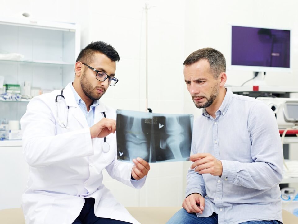 Doctor reviewing an X-ray with a patient